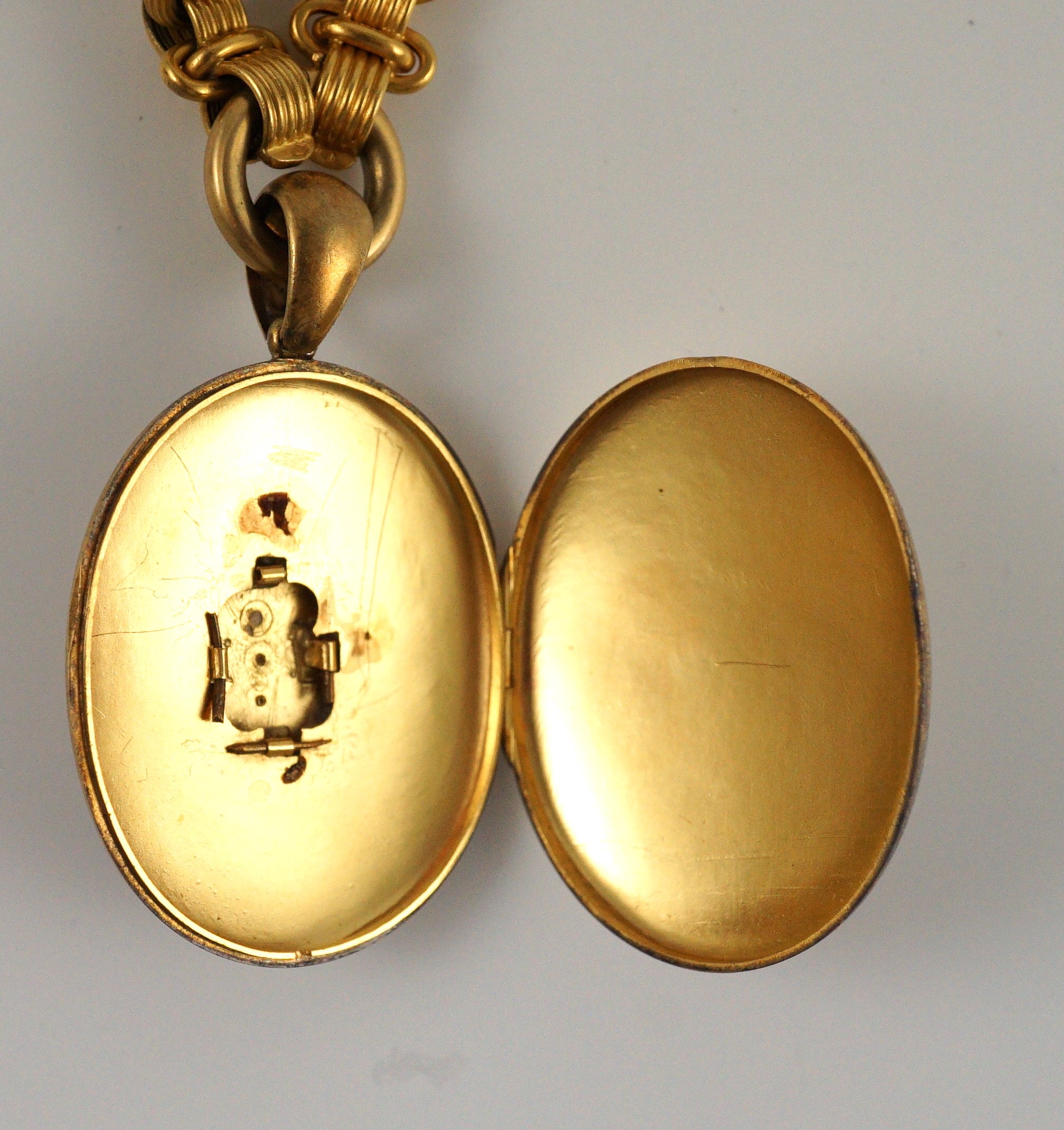 A Victorian gold, enamel and seed pearl set oval locket, on a 19th century Vienna 580/1000 gold chain
